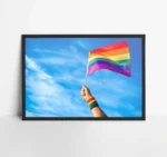 Colorful backlit rainbow gay pride flag being waved in the breeze against a sunset sky Poster