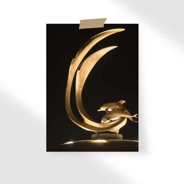 Sculpture of Dolphins at Night Poster